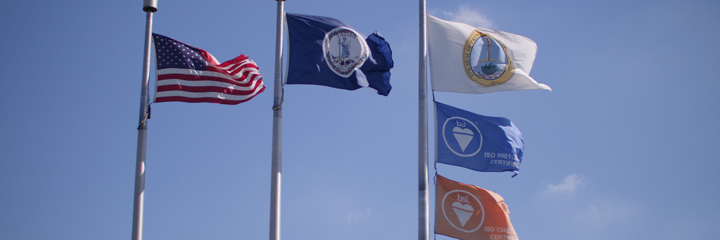 Three flag poles with American flag, Commonwealth of Virginia, Prince William County, and two BSI ISO certified flags.