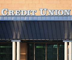 Storefront with a sign that reads credit union over the awning.