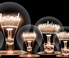 Clear, light bulbs with lit filaments that spell out brand, trust, marketing and advertising.