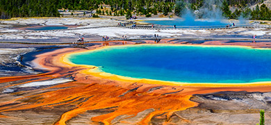 Orange, yellow, blue image of Grand Prismatic Spring in Yellowstone National Park in the US.
