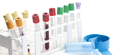 Test tubes with various colored caps in a stand, 2 of the test tubes filled with blood; syringe, tourniquet, and vial nearby.