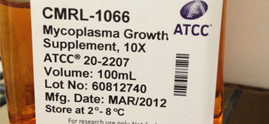 Close up of label on bottle containing orange media, ATCC product labeled: CMRL-1066, mycoplasma growth supplement, 10X.