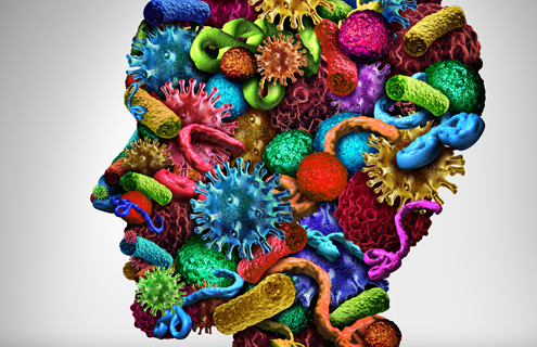 Microbes and bacteria in bright colors combined to form the shape of a human head. Illustration.