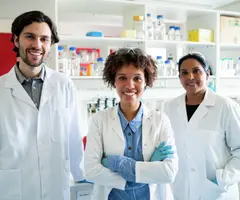 Portrait of scientists smiling in laboratory.