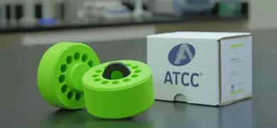 Lid and base of open cell freezing container with empty vial wells and alloy core, next to white box labeled CoolCell LX, ATCC printed on the side.