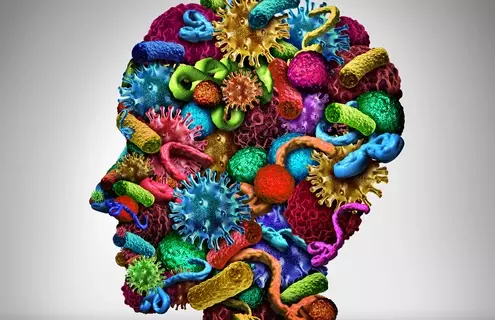 Microbes and bacteria in bright colors combined to form the shape of a human head. Illustration.