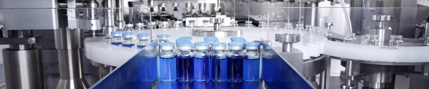 Glass bottles in production in the tray of an automatic liquid dispenser