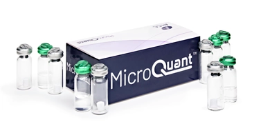 Closed Microquant box surrounded by 10 vials, 5 with green tops and 5 with silver tops