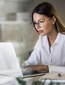 oung businesswoman typing on laptop at home office