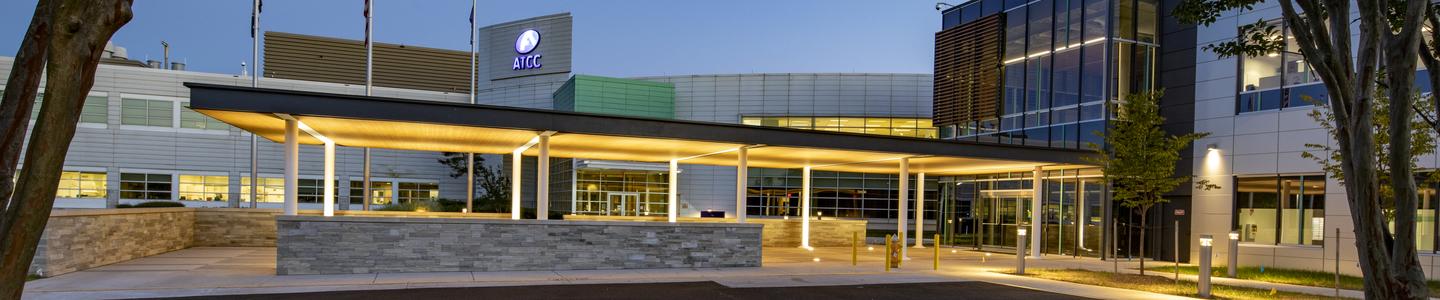 ATCC building entrance at dusk with lights.