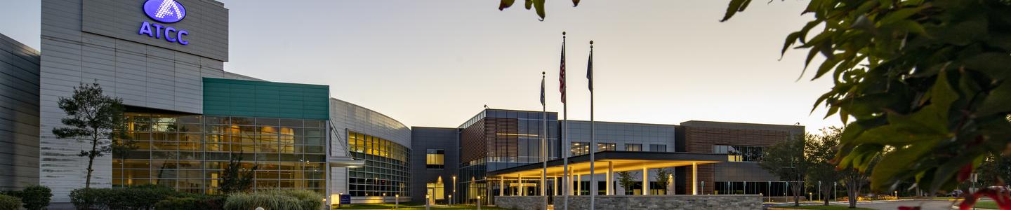 ATCC building entrance at dusk with lights.