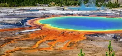 Orange, yellow, blue image of Grand Prismatic Spring in Yellowstone National Park in the US.
