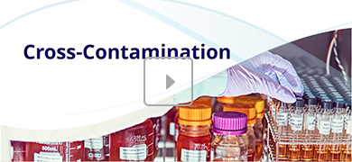 A laboratory scene with various bottles and test tubes, where a gloved hand is handling one of the test tubes. The text "Cross-Contamination" appears in the upper left, and a play button icon is centered, suggesting a video thumbnail.