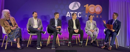 Six panelists seated on stage during ATCC hosted event, 