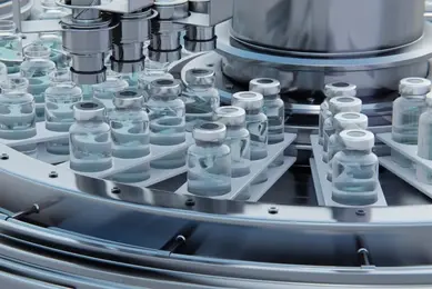 Sterile glass vials being filled with liquid vaccine on an automated production line in a pharmaceutical manufacturing facility.