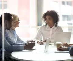 Black female leader talking at diverse group meeting