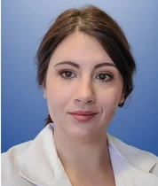 Headshot of Tiffany Cato on blue gradient background